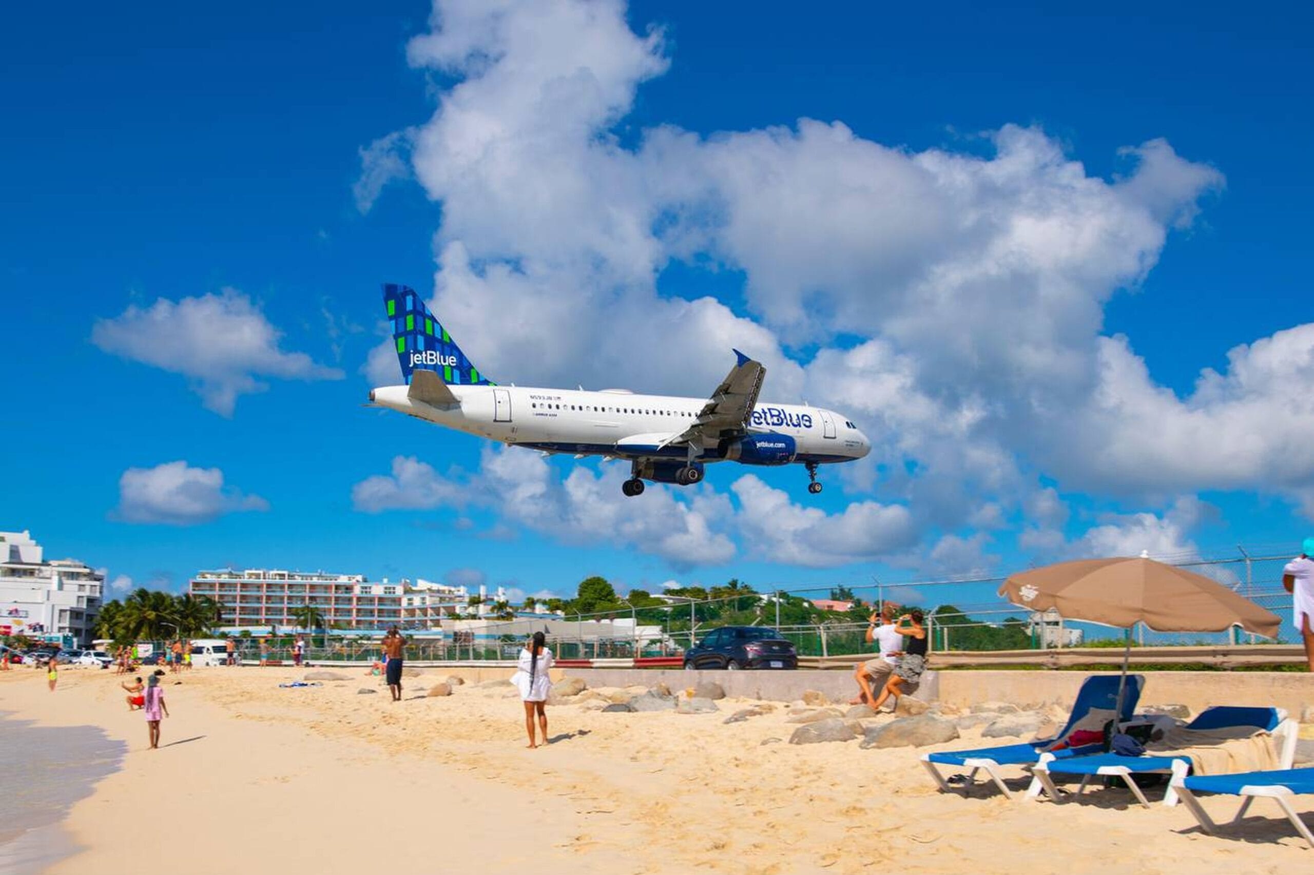 Professional St. Maarten taxi and transfer service for airport, cruise port, and hotel arrivals. Airplane landing over Maho Beach in St. Maarten